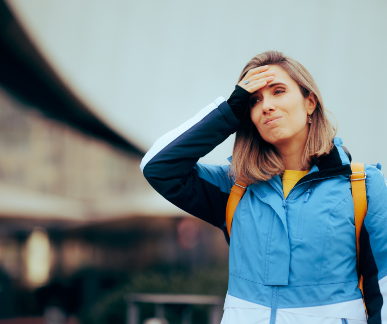 Woman with her hand on her head looking lost.